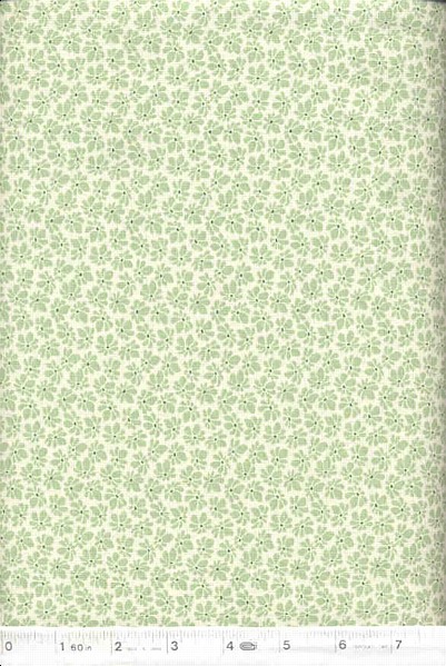 Wonderful feedsack  reproduction fabric with pale green flowers on a white background.