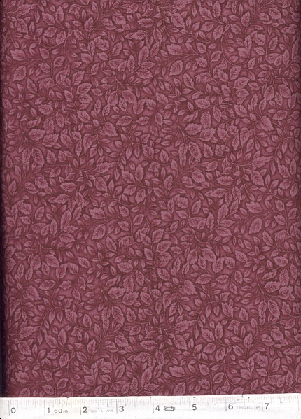 Tea leaves in a dark plum on a lighter plum background.